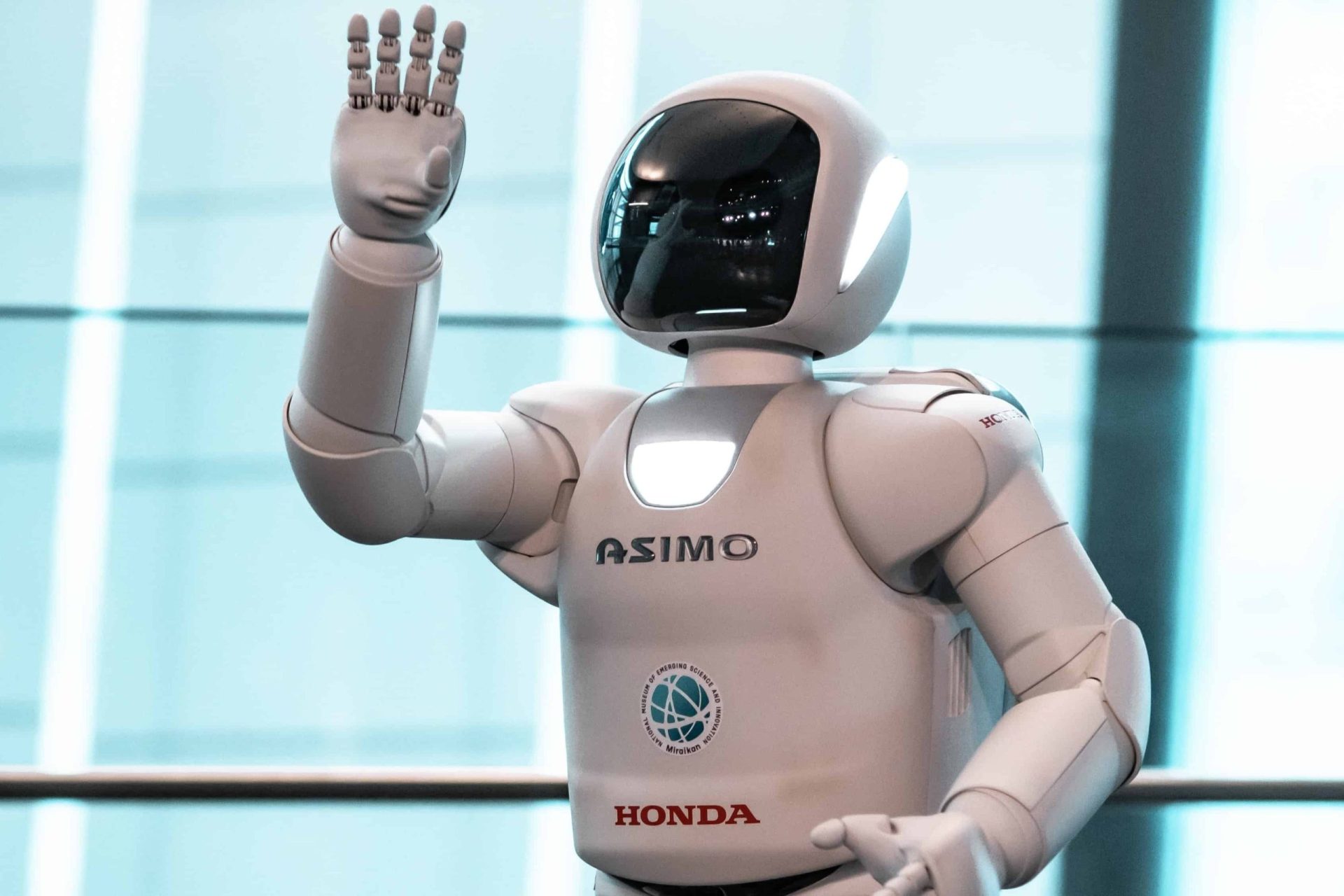 asimo white robot waving