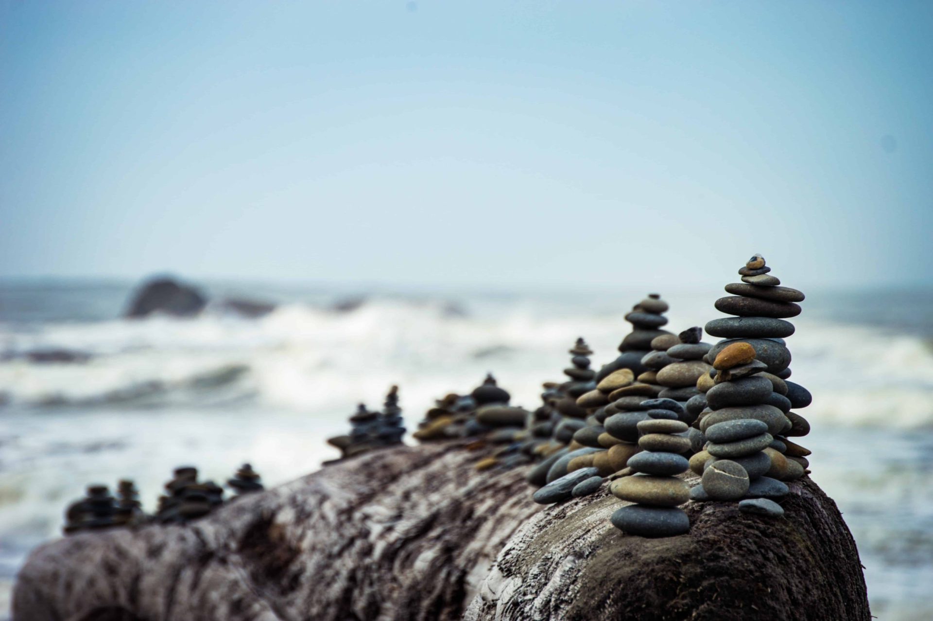 balancing multiple stacks of stones in seaside