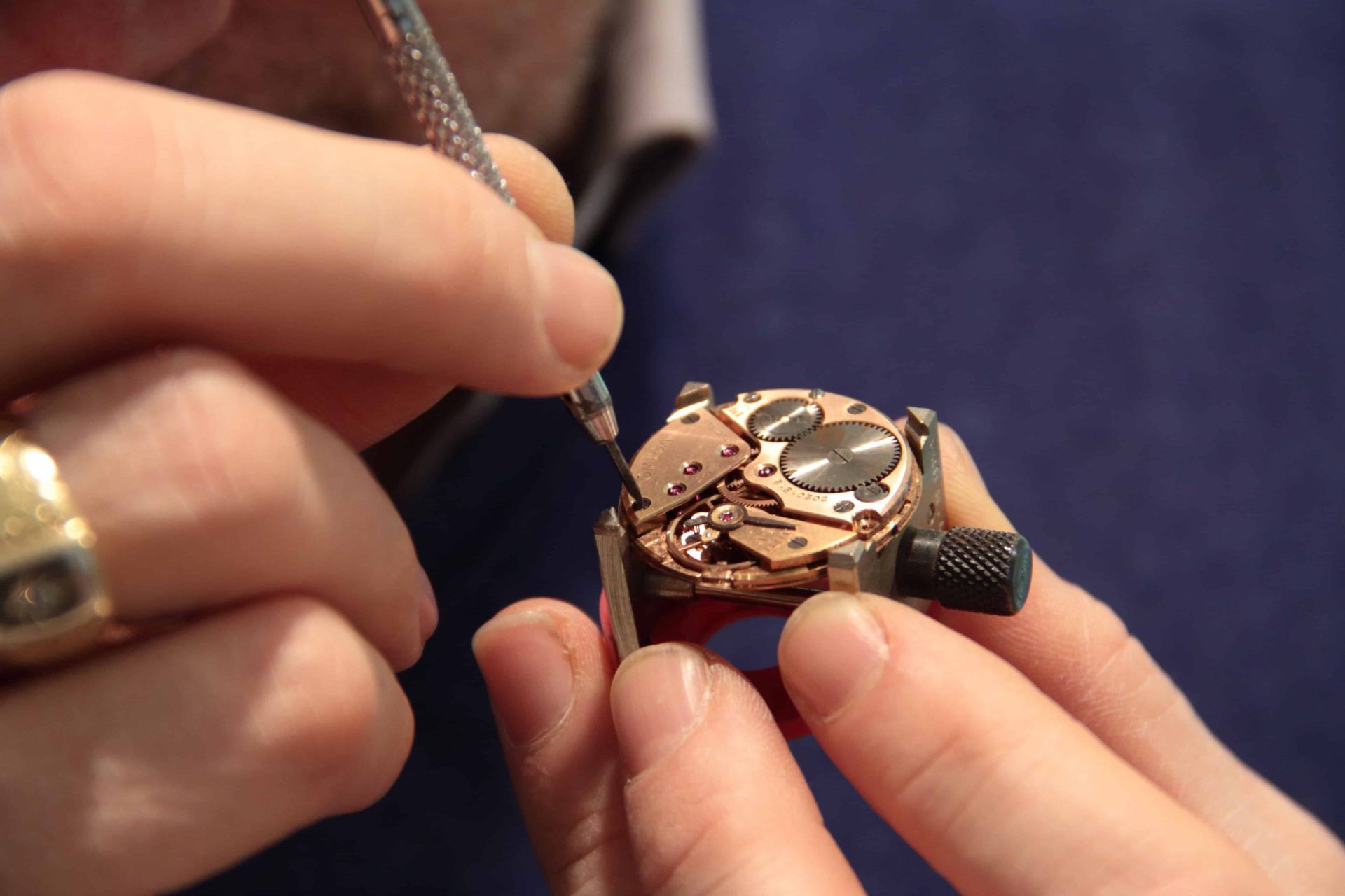 man creating meticulously a small watch