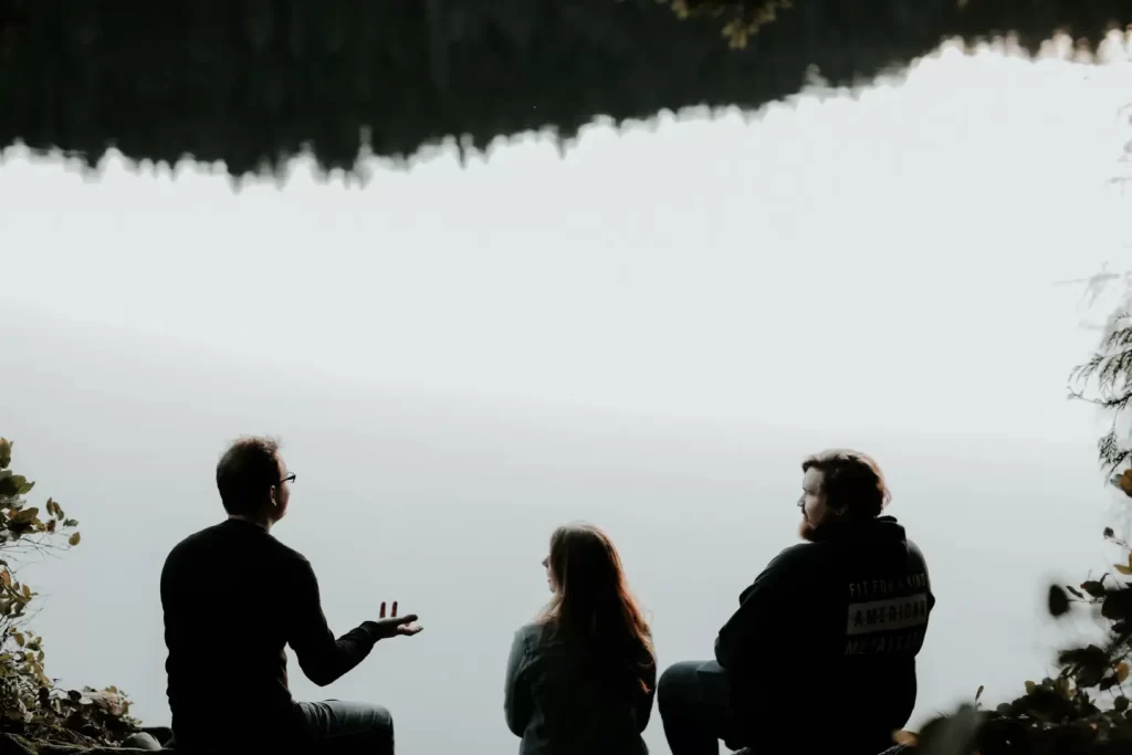 three-people-talking-waterside